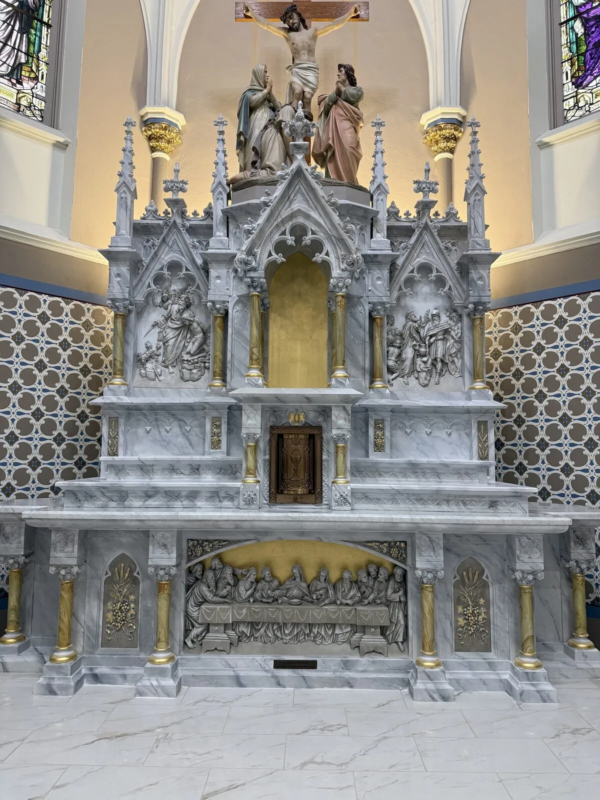 Marbleized high altar with gilt columns and Last Supper relief, front view