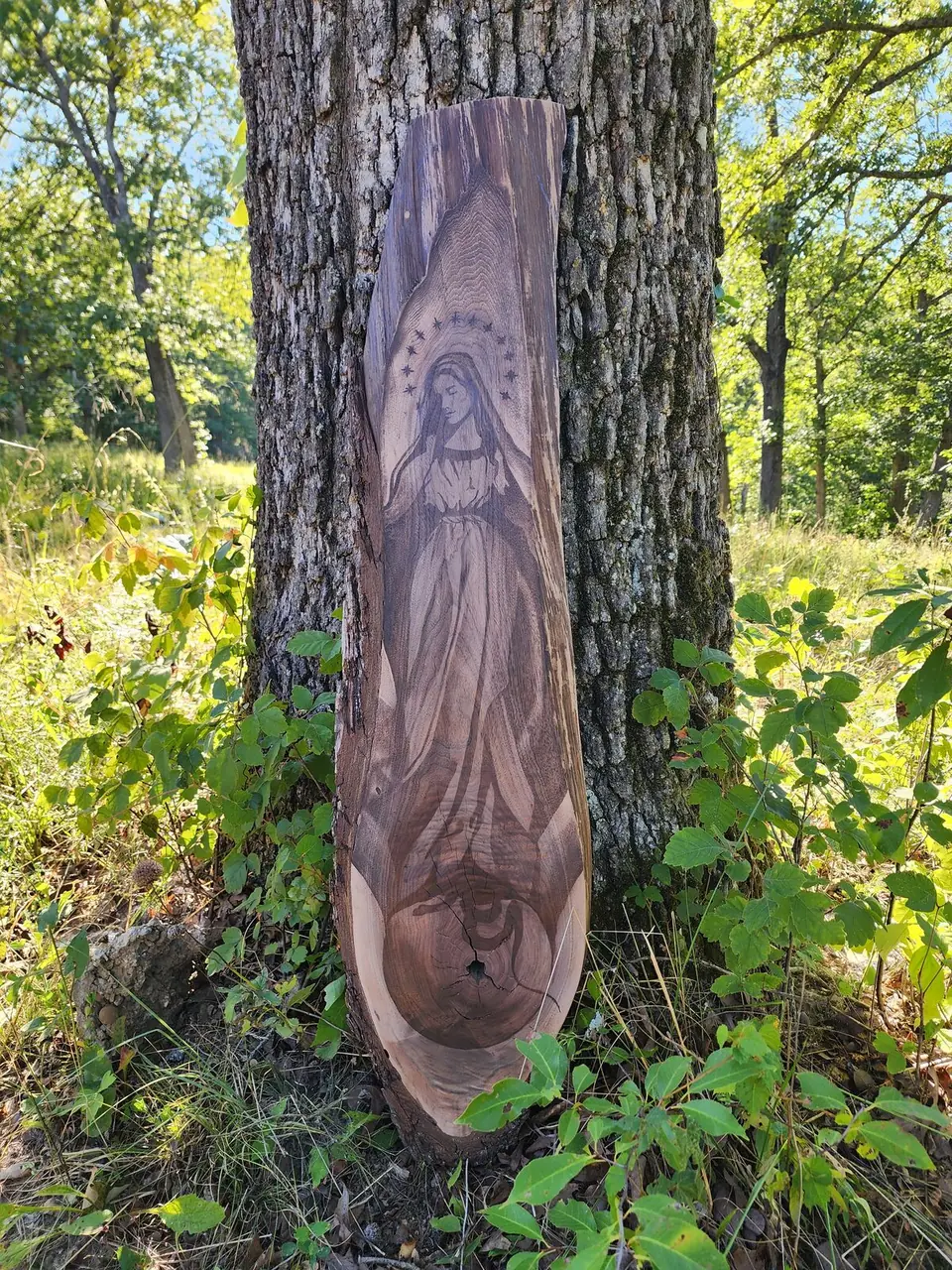 Our Lady with a halo of stars stained into a live-edge slab