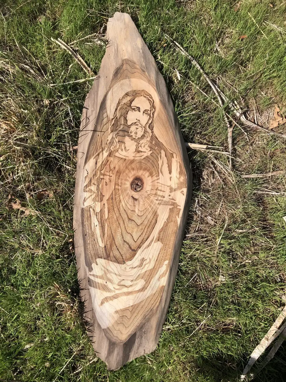 Sacred Heart of Jesus stained into a wood panel